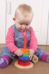 18 month old babby playing with wooden toy