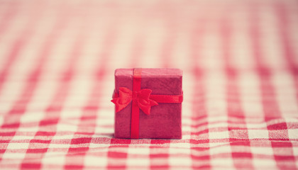 Red gift on tablecloth.