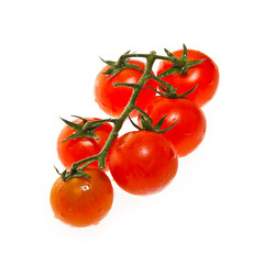 Six ripe cherry tomatoes attached to a main stem