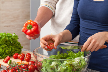 Adding tomatos and pepper to salad