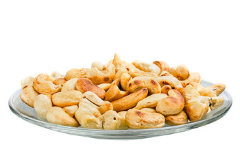 Saucer with roasted cashew nuts isolated on white background