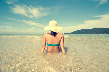 Fototapeta na wymiar female in bikini on beach vintage retro look
