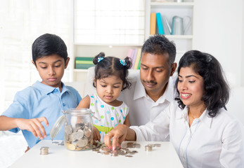 indian family teaching children on savings and financial plannin