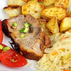 pork with roasted potatoes, tomatoes and sauerkraut