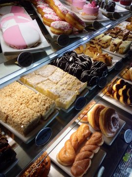 vast variety of pastries in a display case.