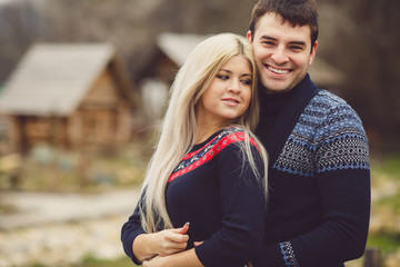 Fototapeta premium Young couple in love walking in autumn park holding hands