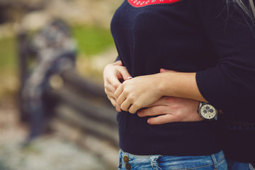 Young couple in love walking in autumn park holding hands