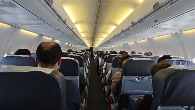 Interior of airplane with passengers on seats