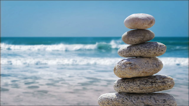 zen balance stone on the beach paradise