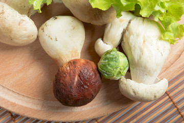 mushrooms and lettuce on a wooden board