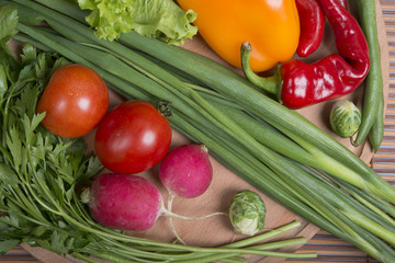 raw vegetables on board and bamboo