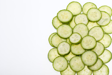 Freshly sliced cucumber  isolated on white background