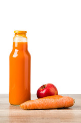 Bottle with carrots juice and an apple