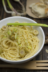 bowl filled with spaghetti pasta and olive