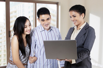 Estate agent with young couple
