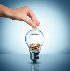 Fototapeta invest to energy concept - euro in bulb - piggybank obraz