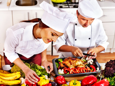 Man And Woman In Chef Hat Cooking Chicken