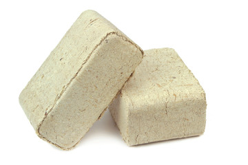 Pressed sawdust, wood briquettes isolated on white background.