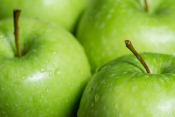 Green apples with water drops.