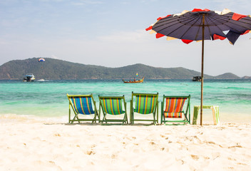 Beach chairs with umbrella and beautiful sand beach