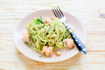 pasta with spinach juice and slices of salmon