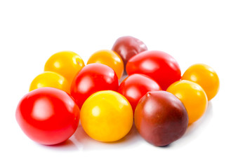 Fresh ripe red, yellow and black cherry tomatoes is isolated on
