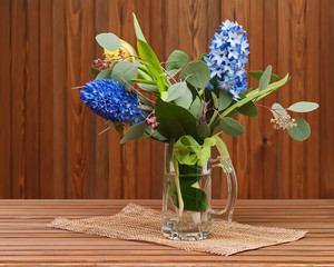 Bouquet from tulips and hyacinths on wooden background.