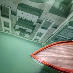 Tuinposter Venice, a wooden boat in a canal © Tatiana Zaghet