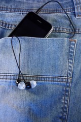 Black phone with headphones in the pocket