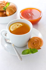Apricot jam pastries and tea with lemon