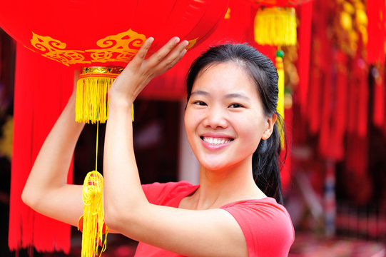 young woman hold a chinese red lantern wishing a happy  new year