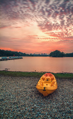 A kayaks resting beside lake of Wetland Putrajaya