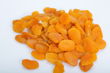 A heap of dried apricots on a white background