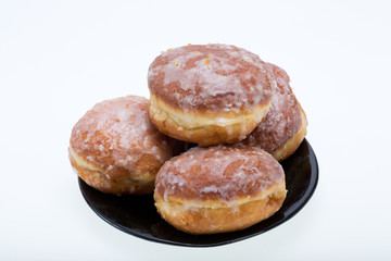 whole donuts on the black porcelain plate