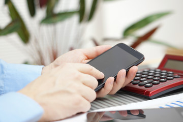 businessman in office working with smart phone, digital tablet