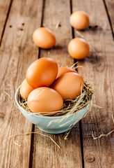 Easter - eggs in a blue bowl on rustic vintage wood