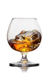 Splash of whiskey with ice in glass isolated on white background