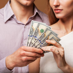 fashion beautiful couple in love holding money the family budget