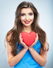 Young happy woman hold Love symbol red heart. Isolated on studi