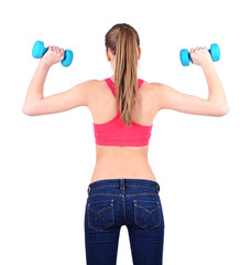 Young beautiful fitness girl exercising with dumbbells,