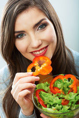 Woman eating green salad . Female model close up face studio is