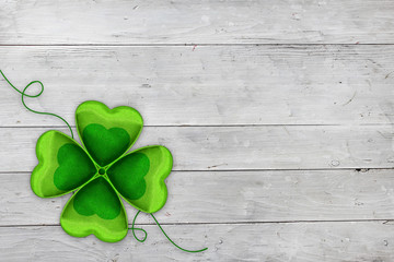 Four leaved clover on wooden background