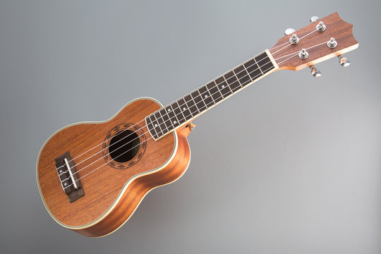 Ukulele guitar on gray background