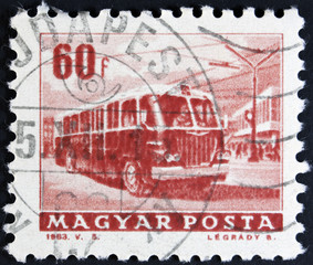 A stamp printed in Hungary shows a Articulated bus