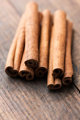 Cinnamon sticks on rustic wooden background
