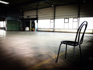 Chair inside empty warehouse 