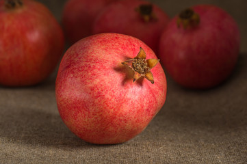 pomegranate on sackcloth background on the garnet group