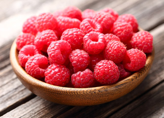 Fresh raspberry in a wooden plate