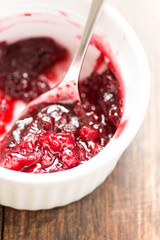 Cranberry sauce on wooden table close up