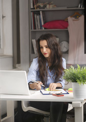 Young businesswoman working at home